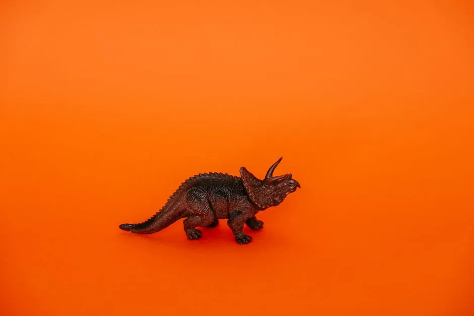 Plastic Triceratops Dinosaur Toy Placed Against A Jigsaw Puzzle Free Online Jigsaw Puzzle
