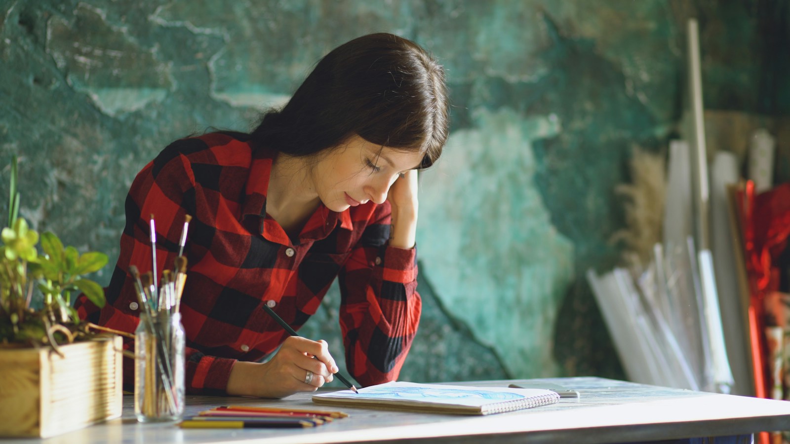 Young Woman Sketching At A Table With Art Supplies Jigsaw Puzzle Free Online Jigsaw Puzzle